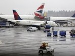 FILE PHOTO: Delta Airlines planes and a British Airways plane (2nd L) are pictured at Seattle-Tacoma International Airport in SeaTac, Washington, U.S. March 13, 2020.  REUTERS/Jason Redmond/File Photo