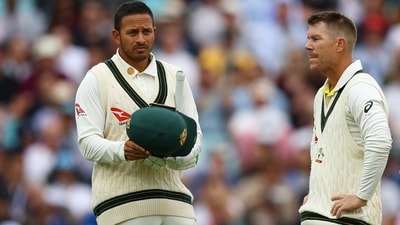 Usman Khawaja and David Warner during a break in play (Reuters)