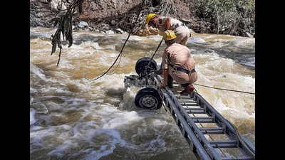 Search and rescue team officials recover mangled remains of a vehicle, that might have washed away in the recent flash floods, from a stream at Gadsa valley in Kullu district on Saturday. (PTI) Search and rescue team officials recover mangled remains of a vehicle, that might have washed away in the recent flash floods, from a stream at Gadsa valley in Kullu district on Saturday. (PTI)