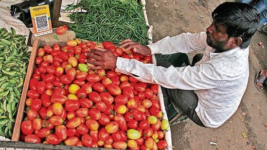 A farmer sells tomatoes in the market. (HT File)