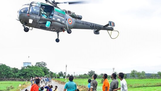 An Indian Air Force helicopter drops relief packets for flood-hit people in Mulugu district of Telangana An Indian Air Force helicopter drops relief packets for flood-hit people in Mulugu district of Telangana
