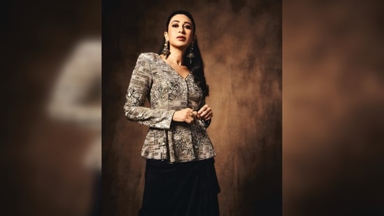 Karisma Kapoor's outfit features a grey shimmery jacket and a black skirt with asymmetrical ruffle detailing.&nbsp;(Instagram/@therealkarismakapoor)
