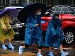 Typhoon Doksuri: People shelter from the rain with umbrellas in Beijing. Typhoon Doksuri: People shelter from the rain with umbrellas in Beijing.