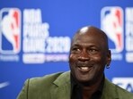 NBA legend Michael Jordan looks on as he addresses a press conference