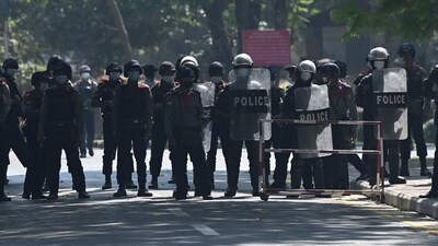 Police block a road in Yangon. (AFP File) Police block a road in Yangon. (AFP File)