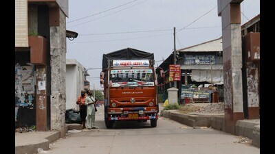 An attendant issuing a parking ticket to a truck driver at the entrance of the vegetable market on Karabara road in Ludhiana. (HT PHOTO)
