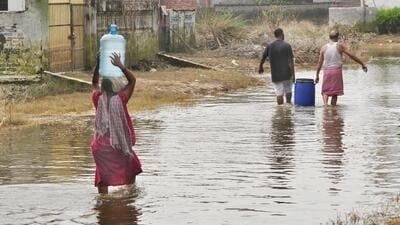 Krishna Colony near Karhera in Ghaziabad on Monday. The water of the Hindon still covers the road as people carry drinking water to their homes. (Sakib Ali/HT Photo) Krishna Colony near Karhera in Ghaziabad on Monday. The water of the Hindon still covers the road as people carry drinking water to their homes. (Sakib Ali/HT Photo)