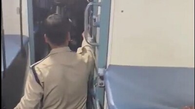 The video, shot by passengers, shows the constable standing beside the body of the victim.