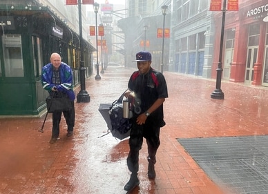 People run towards the atrium entrance at Gallery Place in the Chinatown neighborhood of Washington during heavy rainfall on Saturday, July 29, 2023. The National Weather Service had issued a Severe Thunderstorm Warning across the area. (AP Photo/Pablo Martínez Monsivais) (AP) People run towards the atrium entrance at Gallery Place in the Chinatown neighborhood of Washington during heavy rainfall on Saturday, July 29, 2023. The National Weather Service had issued a Severe Thunderstorm Warning across the area. (AP Photo/Pablo Martínez Monsivais) (AP)