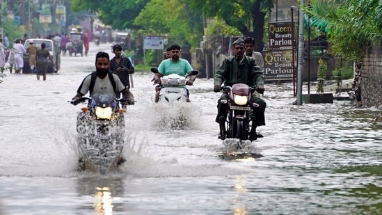 Vehicles wade through a waterlogged road after heavy monsoon rainfall, in Ajmer, Rajasthan.