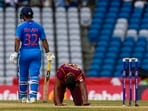 Gudakesh Motie kneels after Ishan Kishan hit a four during the third ODI(AP)