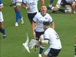 Seagull causes havoc in rugby match, flies in between players.
