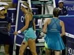 Victoria Azarenka (L) and Elina Svitolina (UKR) (R) walk past one another without shaking hands after their match on day three of the Mubadala Citi DC Open