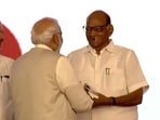 PM Modi and NCP chief Sharad Pawar shaking hands at the Pune awar event on Tuesday.