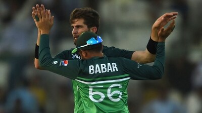 Pakistan's Shaheen Shah Afridi (L) celebrates with Babar Azam after the dismissal of New Zealand's Cole McConchie (AFP)