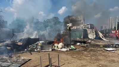 Flames and smoke rise from shops and other temporary structures set ablaze by miscreants in a fresh case of communal violence after Monday's attack on a VHP procession in adjoining Nuh district, in Gurugram on Tuesday. (PTI) Flames and smoke rise from shops and other temporary structures set ablaze by miscreants in a fresh case of communal violence after Monday's attack on a VHP procession in adjoining Nuh district, in Gurugram on Tuesday. (PTI)