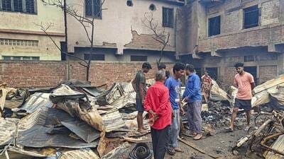 Locals gather near the houses set ablaze, in Imphal (PTI) Locals gather near the houses set ablaze, in Imphal (PTI)