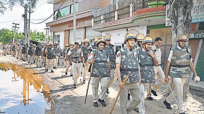 Police officers conduct a flag march near the Nuh bus stand on Tuesday. (Parveen Kumar/HT Photo) Police officers conduct a flag march near the Nuh bus stand on Tuesday. (Parveen Kumar/HT Photo)