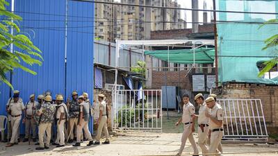 Police personnel outside Anjuman Mosque which was set ablaze in Sector 57 area, in Gurugram on Tuesday. (PTI)