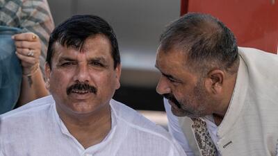 Suspended AAP MP Sanjay Singh with AAP MP Sushil Kumar 'Rinku' at Parliament House complex during the monsoon session in New Delhi on Tuesday. (PTI)