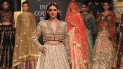 Actor Aditi Rao Hydari turned showstopper for Ritu Kumar. When it comes to exuding royal vibes through fashion, Aditi definitely tops the list. She walked the ramp wearing an ivory ensemble that included a full-sleeved jacket-style blouse adorned with intricate embroidery and mirrorwork. Actor Aditi Rao Hydari turned showstopper for Ritu Kumar. When it comes to exuding royal vibes through fashion, Aditi definitely tops the list. She walked the ramp wearing an ivory ensemble that included a full-sleeved jacket-style blouse adorned with intricate embroidery and mirrorwork.