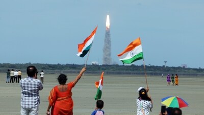 People wave the national flag as they celebrate the launch of Chandrayaan-3 mission from the Satish Dhawan Space Centre, in Sriharikota on Friday. (ANI) People wave the national flag as they celebrate the launch of Chandrayaan-3 mission from the Satish Dhawan Space Centre, in Sriharikota on Friday. (ANI)