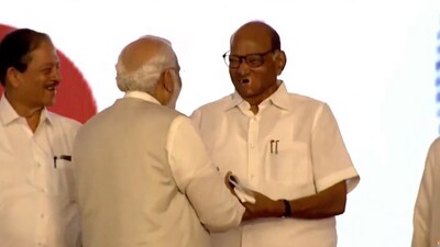 PM Modi and NCP chief Sharad Pawar shaking hands at the Pune awar event on Tuesday. PM Modi and NCP chief Sharad Pawar shaking hands at the Pune awar event on Tuesday.