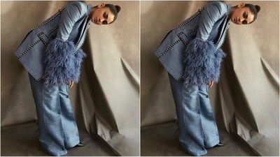 Mrunal's baby-blue pantsuit features an oversized blazer with retro-style black lace detailing and fur-adorned dramatic sleeves. She teamed it with a matching pair of flared pants. (Instagram/@mrunalthakur) Mrunal's baby-blue pantsuit features an oversized blazer with retro-style black lace detailing and fur-adorned dramatic sleeves. She teamed it with a matching pair of flared pants. (Instagram/@mrunalthakur)