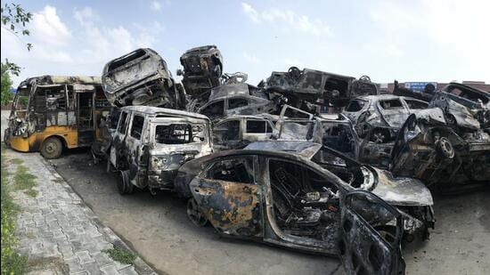 Vehicles torched by mobs at the Nuh bus stand on Tuesday. (Parveen Kumar/HT Photo)