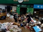 Beijing Floods: People sort items outside a supermarket, after the rains and floods brought by remnants of Typhoon Doksuri, in Beijing, China.