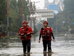 Rescue workers wade through floodwaters after remnants of Typhoon Doksuri brought rains and floods in Beijing, China August 2, 2023. (Reuters)