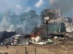 Flames and smoke rise from shops and other temporary structures set ablaze by miscreants in a fresh case of communal violence after Monday's attack on a VHP procession in adjoining Nuh district, in Gurugram on Tuesday. (PTI)