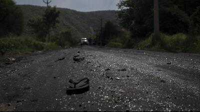 A sandal lies on a road next to scattered glass from vehicles vandalized during communal clashes in Nuh in Haryana state. (AP)