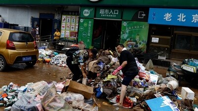 Beijing Floods: People sort items outside a supermarket, after the rains and floods brought by remnants of Typhoon Doksuri, in Beijing, China. (Reuters)