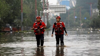 Rescue workers wade through floodwaters after remnants of Typhoon Doksuri brought rains and floods in Beijing, China August 2, 2023. (Reuters)
