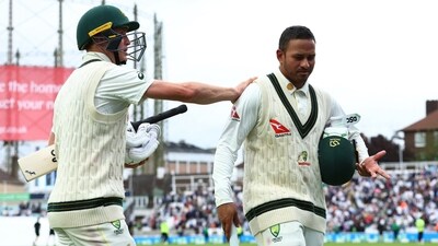 Usman Khawaja and Marnus Labuschagne walk off the field (Reuters)