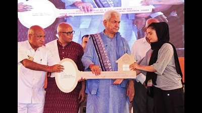 Jammu and Kashmir lieutenant governor Manoj Sinha handing over a key of a flat to a beneficiary during the inauguration of affordable Rental Housing Complex at Sunjwan in Jammu on Wednesday. (ANI Photo) Jammu and Kashmir lieutenant governor Manoj Sinha handing over a key of a flat to a beneficiary during the inauguration of affordable Rental Housing Complex at Sunjwan in Jammu on Wednesday. (ANI Photo)
