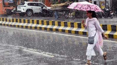 A lady using umbrellas during rain in Patna , Bihar,India.
