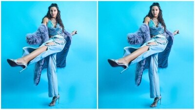 For her look, Nora picked an outfit from the shelves of Nikita karizma. Her look features a blue top with a halterneck, plunging neckline and shimmer detailing all over. She paired it with matching shorts and wore flared inside-out distressed denim over it for a unique look. The addition of a purple fur jacket took her look to the next level. (Instagram/@norafatehi) For her look, Nora picked an outfit from the shelves of Nikita karizma. Her look features a blue top with a halterneck, plunging neckline and shimmer detailing all over. She paired it with matching shorts and wore flared inside-out distressed denim over it for a unique look. The addition of a purple fur jacket took her look to the next level. (Instagram/@norafatehi)