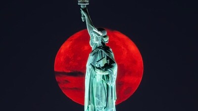 The supermoon sets behind the Statue of Liberty just before 5am. A supermoon is broadly defined as a full moon that is closer to the Earth than normal. That makes it appear slightly brighter and bigger in the sky.&nbsp; (Twitter/@@DanTVusa)