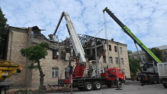Rescuers clear debris after a drone hit an educational establishment, in Kharkiv, on August 1, 2023, amid the Russian invasion of Ukraine. (AFP)