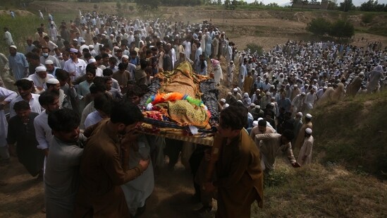 Relatives and mourners carry the casket of a victim who was killed in Sunday's suicide bomber attack in the Bajur district of Khyber Pakhtunkhwa, Pakistan, Monday. (AP)