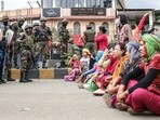 Paramilitary personnel stand guard as people stage a protest against the mass burial of Kuki-Zomi people killed in Manipur's ethnic violence, in Imphal on Thursday. (ANI Photo)
Paramilitary personnel stand guard as people stage a protest against the mass burial of Kuki-Zomi people killed in Manipur's ethnic violence, in Imphal on Thursday. (ANI Photo)