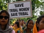 Members of tribal community hold placards and gestures during protest over violence against women and for peace in the ongoing ethnic violence in Manipur, in New Delhi on August 3. Members of tribal community hold placards and gestures during protest over violence against women and for peace in the ongoing ethnic violence in Manipur, in New Delhi on August 3.