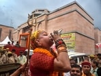 Mahamandaleshwar Hemangi Sakhi of Kinnar Akhara blows a conch after the Allahabad High Court gave the go-ahead for a scientific survey at Gyanvapi Monsque, in Varanasi, Thursday.