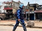 Riot police patrolling a street in Nuh. (AFP) Riot police patrolling a street in Nuh. (AFP)
