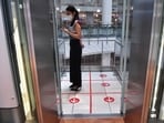 Woman seen standing inside a lift.