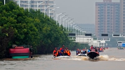 China: Rescuers using rubber boats evacuate trapped residents as a truck, left, is seen submerged by floodwaters in Zhuozhou in northern China's Hebei province, south of Beijing, Wednesday. China's capital has recorded its heaviest rainfall in at least 140 years over the past few days. The floods, triggered by incessant rain have have 21 people so far. (AP)