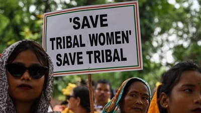 Members of tribal community hold placards and gestures during protest over violence against women and for peace in the ongoing ethnic violence in Manipur, in New Delhi on August 3. (AFP) Members of tribal community hold placards and gestures during protest over violence against women and for peace in the ongoing ethnic violence in Manipur, in New Delhi on August 3. (AFP)