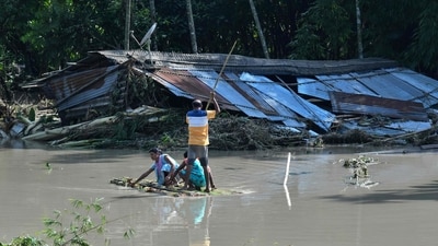 India: People walk across a makeshift bamboo bridge after a section of a bridge over the Daranga River washed away after a flash floods following monsoon rains in Kumarikata village of Baska district, some 52 km from Guwahati in India's Assam state on June 23, 2023. At least 19 people are dead after floods triggered by the annual monsoon, with a week of relentless rains forcing thousands of people to seek shelter in Assam. (AFP)
